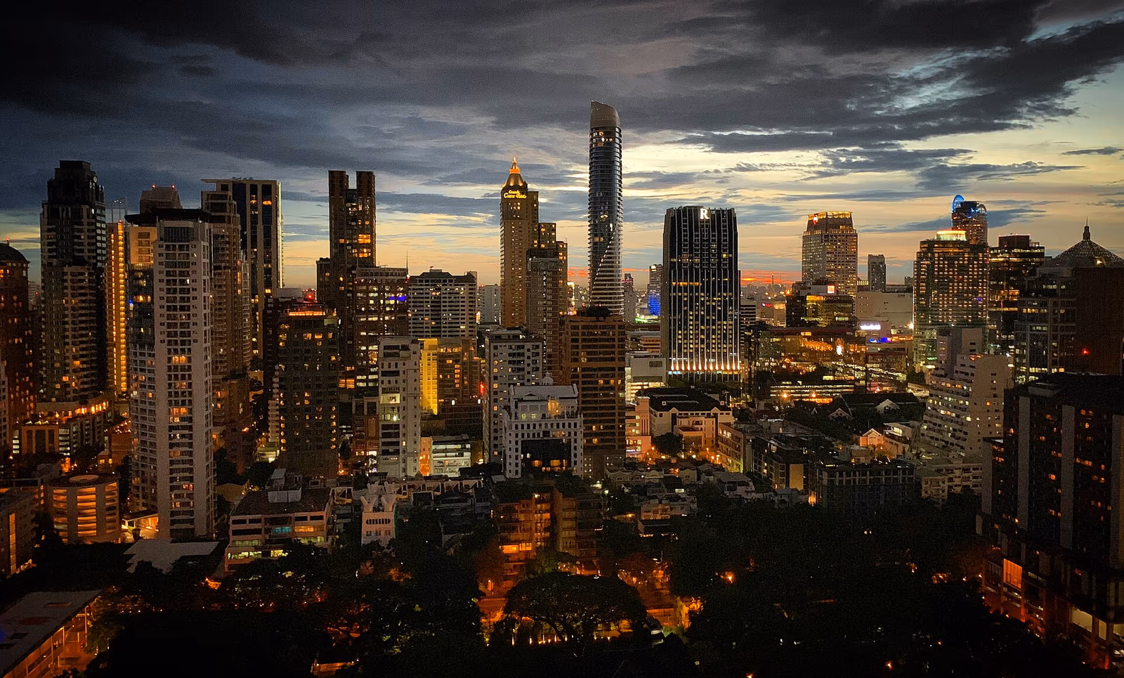 Raimon Land portfolio skyline illustration with Bangkok luxury towers and Pattaya Northpoint and Zire Wongamat beachfront developments