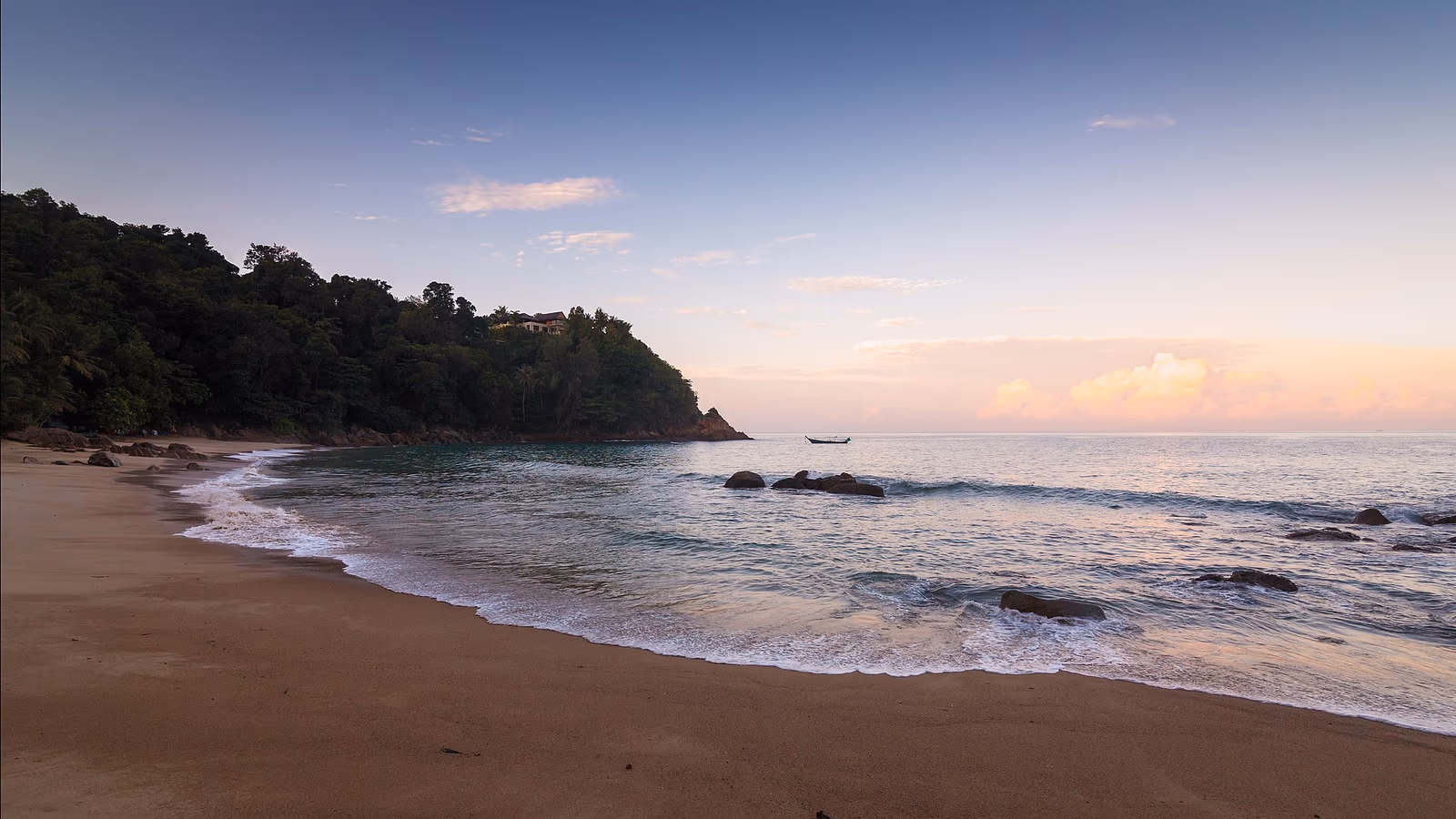Phuket west coast beachfront with branded residences and palm-lined resort beach